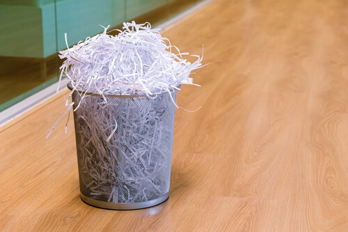 waste paper bin with shredded paper overflowing